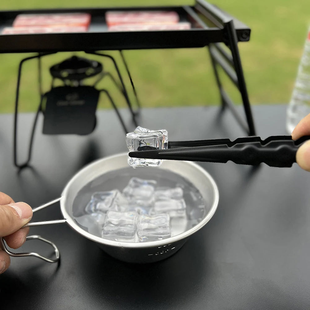 Black metal hookah charcoal tongs in use, lifestyle photo showing safe charcoal handling over hookah bowl, heat-resistant design